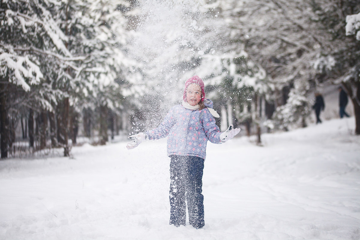 Девочка играет со снегом
